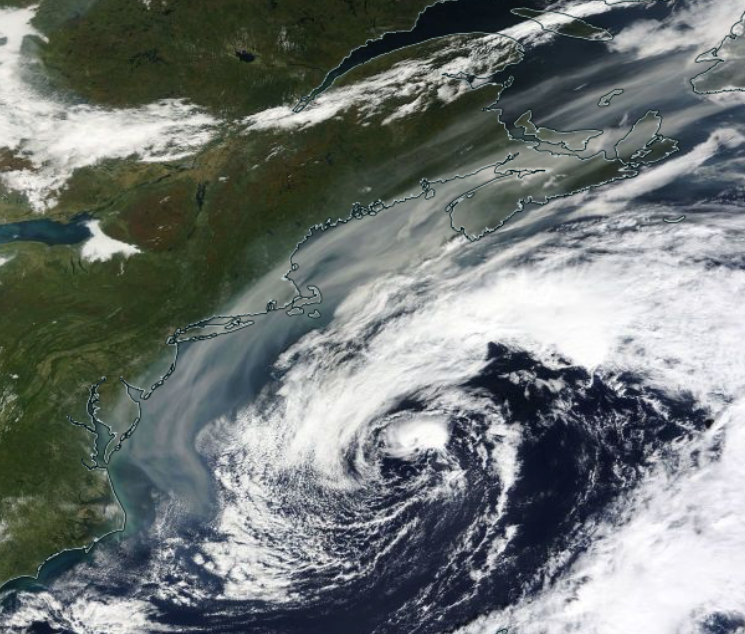 Smoke (gray shading) circulating around the back side of an offshore low on the morning of October 1st (NASA Terra).