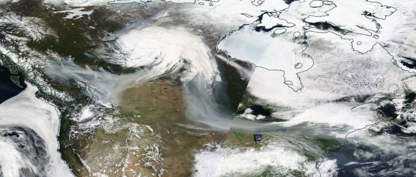 Visible satellite composite across North America on the morning of May 16th. Smoke (greyer than most clouds and snow-covered ground) can be seen emerging from wildfires in western Canada, being pulled into a low-pressure system to the east, and then flowing south and east by upper-level winds into the northern US Plains, across the Great Lakes and into the Northeast.