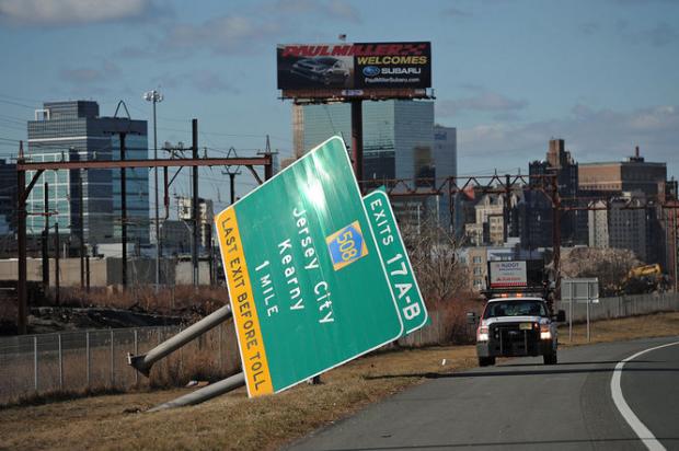 Highway sign knocked over by the wind